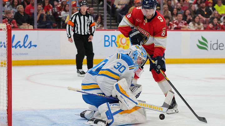Dec 20, 2025; Sunrise, Florida, USA; St. Louis Blues goaltender Joel Hofer (30) makes a save against Florida Panthers center Sam Bennett (9) during the second period at Amerant Bank Arena. Mandatory Credit: Sam Navarro-Imagn Images