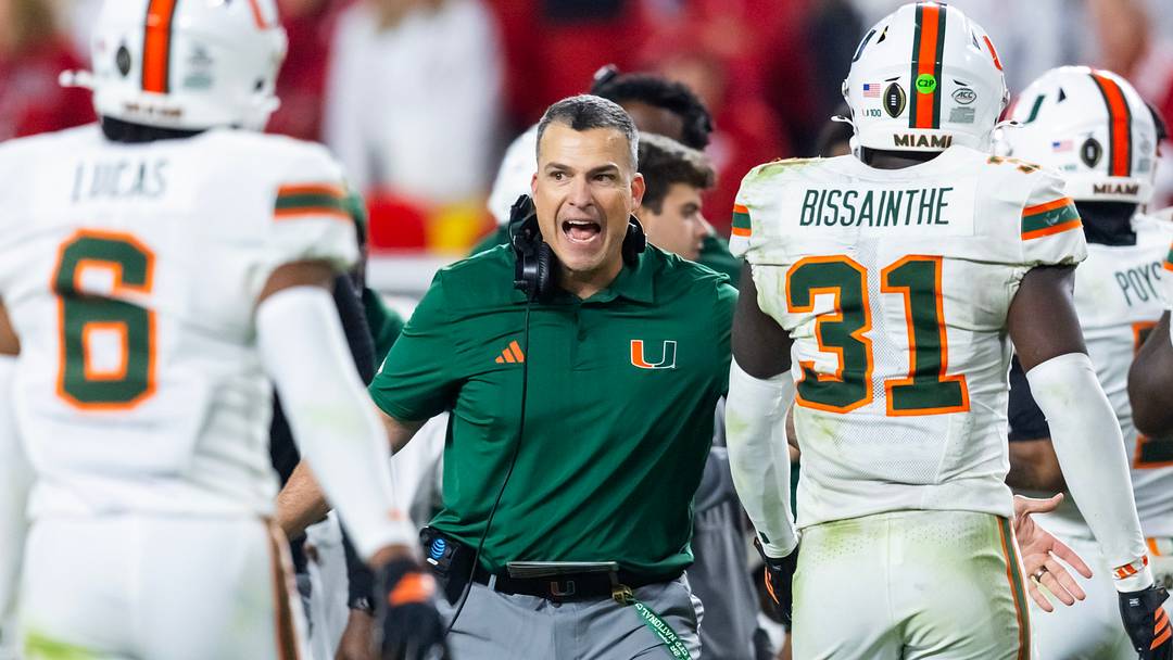 Jan 19, 2026; Miami Gardens, FL, USA; Miami Hurricanes head coach Mario Cristobal with linebacker Wesley Bissainthe (31) against the Indiana Hoosiers during the College Football Playoff National Championship game at Hard Rock Stadium. Mandatory Credit: Mark J. Rebilas-Imagn Images