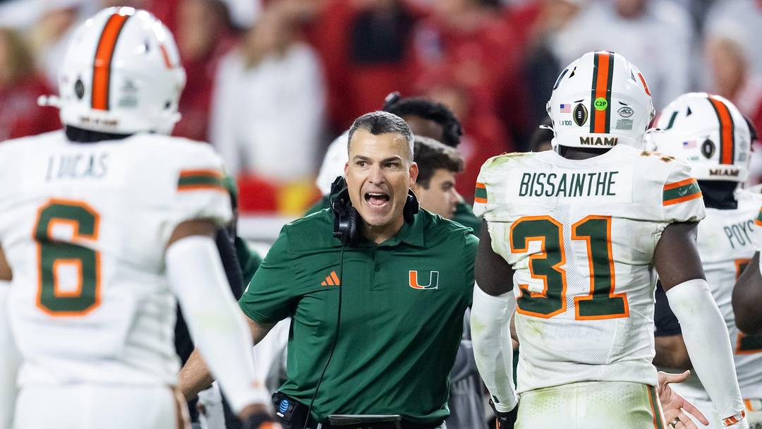 Jan 19, 2026; Miami Gardens, FL, USA; Miami Hurricanes head coach Mario Cristobal with linebacker Wesley Bissainthe (31) against the Indiana Hoosiers during the College Football Playoff National Championship game at Hard Rock Stadium. Mandatory Credit: Mark J. Rebilas-Imagn Images