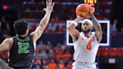 Dec 29, 2024; Champaign, Illinois, USA;  Illinois Fighting Illini guard Kylan Boswell (4) shoots the ball over Chicago State Cougars guard Gabe Spinelli (12) during the first half at State Farm Center. Mandatory Credit: Ron Johnson-Imagn Images