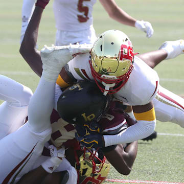 Iona prep's Steven Dowdy Jr. is tackled by Bergen Catholic's Kaden Irby-Mason, left, and Jordan Thomas during their game at Iona Prep Sept. 14, 2024. Bergen Catholic won 31-10.