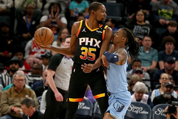 Phoenix Suns forward Kevin Durant (35) handles the ball as Memphis Grizzlies guard Ja Morant (12) defends