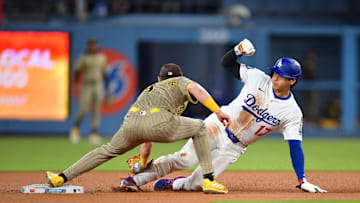 Aug 15, 2025; Los Angeles, California, USA;  Los Angeles Dodgers designated hitter Shohei Ohtani (17) is caught stealing by San Diego Padres second base Jake Cronenworth (9) during the third inning at Dodger Stadium. Mandatory Credit: Gary A. Vasquez-Imagn Images