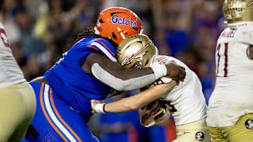 Florida Gators defensive lineman Desmond Watson (21) sacks Florida State Seminoles quarterback Tate Rodemaker (18) during the second half at Steve Spurrier Field at Ben Hill Griffin Stadium in Gainesville, FL on Saturday, November 25, 2023. [Matt Pendleton/Gainesville Sun]