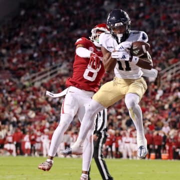 Nov 18, 2023; Fayetteville, Arkansas, USA; FIU Panthers wide receiver Dean Patterson (11) catches a pass for a touchdown in the first quarter as Arkansas Razorbacks defensive back Jayden Johnson (8) defends at Donald W. Reynolds Razorback Stadium. Mandatory Credit: Nelson Chenault-USA TODAY Sports