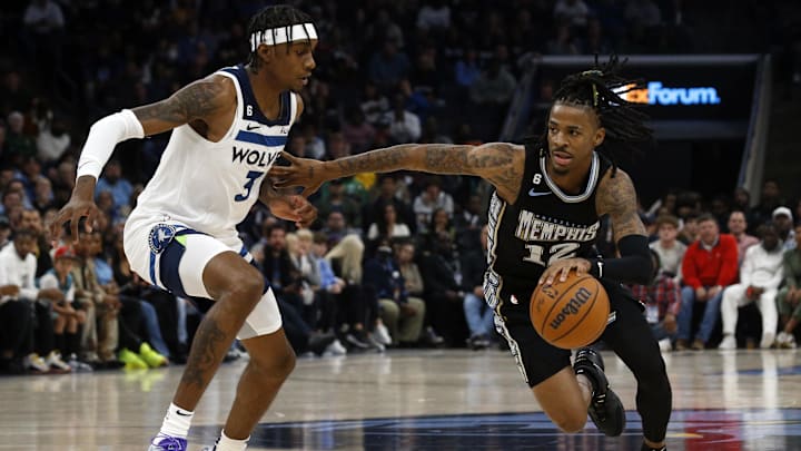 Nov 11, 2022; Memphis, Tennessee, USA; Memphis Grizzlies guard Ja Morant (12) drives to the basket as Minnesota Timberwolves forward Jaden McDaniels (3) during the first half at FedExForum.