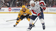 Nov 6, 2025; Pittsburgh, Pennsylvania, USA;  Washington Capitals defenseman John Carlson (74) moves the puck ahead of Pittsburgh Penguins right wing Philip Tomasino (53) during the second period at PPG Paints Arena. Mandatory Credit: Charles LeClaire-Imagn Images