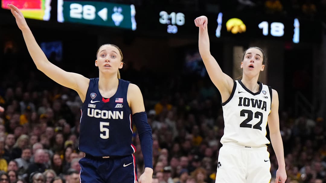 Apr 5, 2024; Cleveland, OH, USA; Iowa Hawkeyes guard Caitlin Clark (22) and Connecticut Huskies guard Paige Bueckers (5) react in the second quarter in the semifinals of the Final Four of the womens 2024 NCAA Tournament at Rocket Mortgage FieldHouse. Mandatory Credit: Kirby Lee-Imagn Images