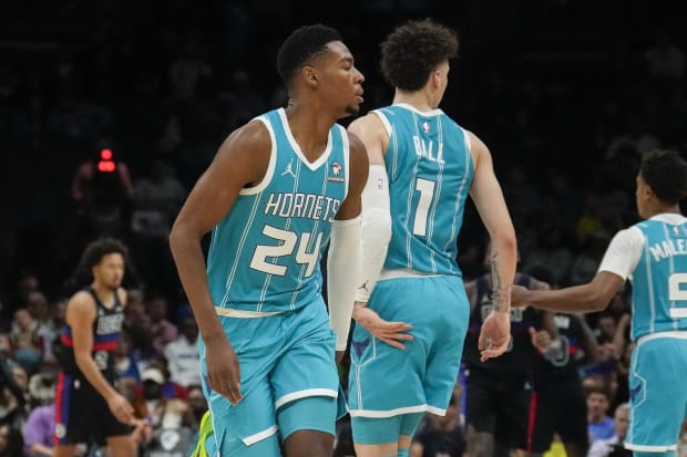 Charlotte Hornets guard LaMelo Ball (1) gives forward Brandon Miller (24) a low high five.