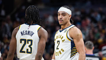 Feb 1, 2025; Indianapolis, Indiana, USA; Indiana Pacers guard Andrew Nembhard (2) celebrates with forward Aaron Nesmith (23) after a foul and basket against the Atlanta Hawks in the second half at Gainbridge Fieldhouse. Mandatory Credit: Trevor Ruszkowski-Imagn Images