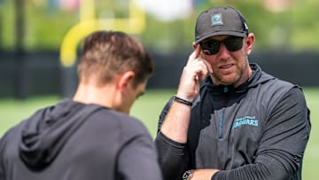 Jacksonville Jaguars general manager James Gladstone, left, talks with Jacksonville Jaguars head coach Liam Coen, right, after the. Jacksonville Jaguars’ mandatory minicamp Tuesday June 10, 2025 at the Miller Electric Center in Jacksonville, Fla. [
