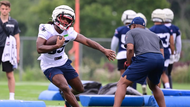 Jul 24, 2024; Foxborough, MA, USA;  New England Patriots running back Deshaun Fenwick (35) works with skills development, kick/punt returners coach Troy Brown during training camp at Gillette Stadium. Mandatory Credit: Eric Canha-USA TODAY Sports