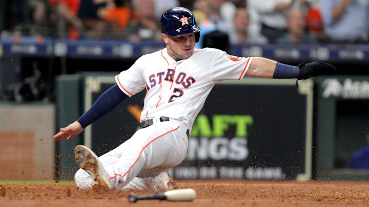 May 29, 2019; Houston, TX, USA; Houston Astros third baseman Alex Bregman (2) slides across home plate to score a run against the Chicago Cubs during the fourth inning at Minute Maid Park.