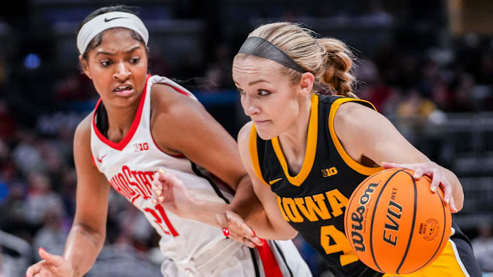 Ohio State Buckeyes guard Chance Gray (21) guards Iowa Hawkeyes guard Kylie Feuerbach (4) on Friday, March 7, 2025, in a quarterfinals game at the 2025 TIAA Big Ten Women's Basketball Tournament between the Iowa Hawkeyes and the Ohio State Buckeyes at Gainbridge Fieldhouse in Indianapolis. The Buckeyes defeated the Hawkeyes, 60-59.