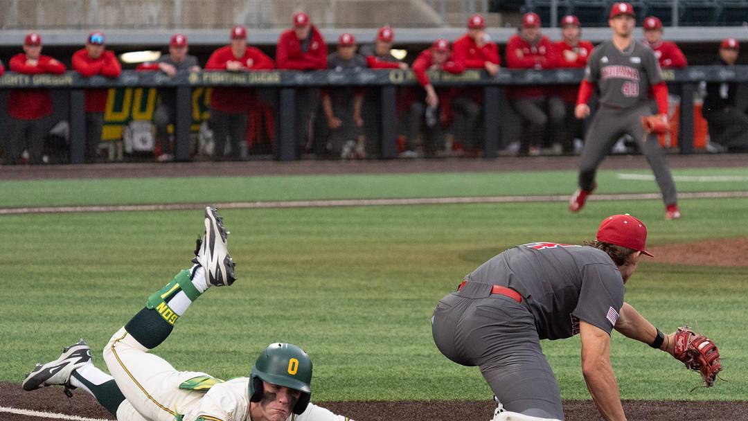 Oregon’s Jax Gimenez, left, dives to first ahead of the tag by Indiana’s
Jake Hanley at PK Park in Eugene March 13, 2026. Oregon’s Jax Gimenez, left, dives to first ahead of the tag by Indiana’s
Jake Hanley at PK Park in Eugene March 13, 2026.