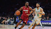 Mar 14, 2025; Miami, Florida, USA; Miami Heat forward Andrew Wiggins (22) drives to the basket against Boston Celtics forward Jayson Tatum (0) during the first quarter at Kaseya Center. Mandatory Credit: Sam Navarro-Imagn Images