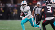 Oct 26, 2025; Atlanta, Georgia, USA; Miami Dolphins running back De'Von Achane (28) runs the ball against the Atlanta Falcons in the second quarter at Mercedes-Benz Stadium. Mandatory Credit: Brett Davis-Imagn Images