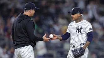 May 20, 2024; Bronx, New York, USA; New York Yankees starting pitcher Marcus Stroman (0) hands the ball off.