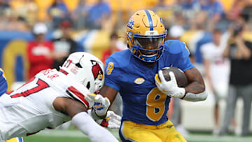 Sep 27, 2025; Pittsburgh, Pennsylvania, USA;  Pittsburgh Panthers running back Juelz Goff (8) runs the ball against Louisville Cardinals defensive back JoJo Evans Jr. (27) during the first quarter at Acrisure Stadium. Mandatory Credit: Charles LeClaire-Imagn Images