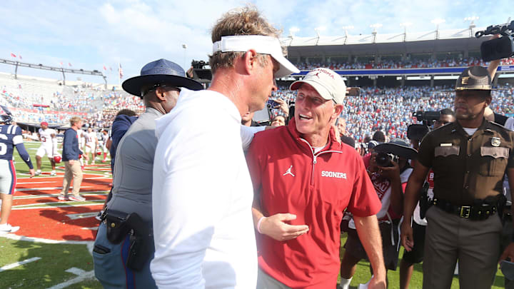 Oct 26, 2024; Oxford, Mississippi, USA; Oklahoma Sooners head coach Brent Venables (right) and Mississippi Rebels head coach Lane Kiffin talk after the game at Vaught-Hemingway Stadium. Mandatory Credit: Petre Thomas-Imagn Images
