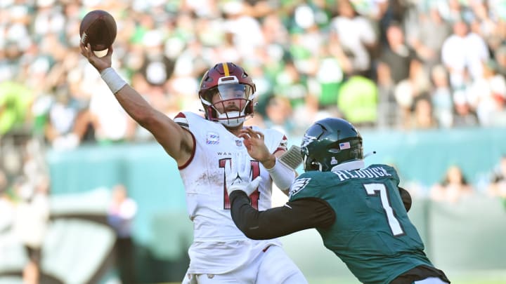 Oct 1, 2023; Philadelphia, Pennsylvania, USA; Washington Commanders quarterback Sam Howell (14) throws pass under pressure from Philadelphia Eagles linebacker Haason Reddick (7) during the fourth quarter at Lincoln Financial Field.