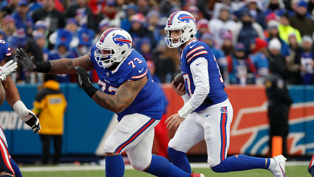 Buffalo Bills quarterback Josh Allen (17) follows a block by Buffalo Bills offensive tackle Dion Dawkins (73) on this first down run.