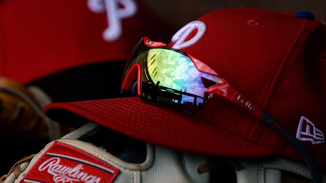 A view of the sky and ballpark in the reflection of a pair of sunglasses in the dugout on an official Phillies New Era cap in the game of the Philadelphia Phillies against the Cincinnati Reds at Great American Ball Park. 