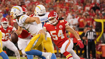 Sep 15, 2022; Kansas City, Missouri, USA; Los Angeles Chargers quarterback Justin Herbert (10) and Kansas City Chiefs linebacker Leo Chenal (54) during the game at GEHA Field at Arrowhead Stadium. Mandatory Credit: Denny Medley-Imagn Images