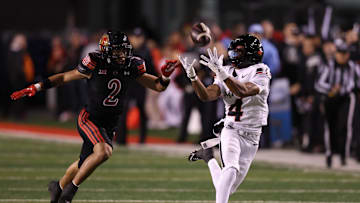 Nov 1, 2025; Salt Lake City, Utah, USA; Cincinnati Bearcats wide receiver Cyrus Allen (4) makes a catch against Utah Utes cornerback Smith Snowden (2) during the second quarter at Rice-Eccles Stadium. Mandatory Credit: Rob Gray-Imagn Images