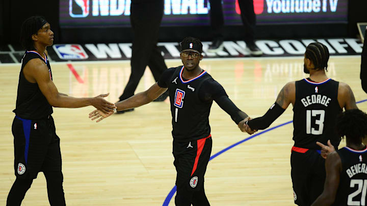 Jun 30, 2021; Los Angeles, California, USA; Los Angeles Clippers guard Reggie Jackson (1) reacts with guard Terance Mann (14) and guard Paul George (13) after scoring a basket and drawing the foul against the Phoenix Suns during the first half in game six of the Western Conference Finals for the 2021 NBA Playoffs at Staples Center. Mandatory Credit: Gary A. Vasquez-Imagn Images