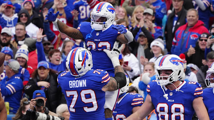 Nov 3, 2024; Orchard Park, New York, USA; Buffalo Bills offensive tackle Spencer Brown (79) lifts up Buffalo Bills running back Ray Davis (22) to celebrate him scoring a touchdown against the Miami Dolphins during the second half at Highmark Stadium Nov 3, 2024; Orchard Park, New York, USA; Buffalo Bills offensive tackle Spencer Brown (79) lifts up Buffalo Bills running back Ray Davis (22) to celebrate him scoring a touchdown against the Miami Dolphins during the second half at Highmark Stadium
