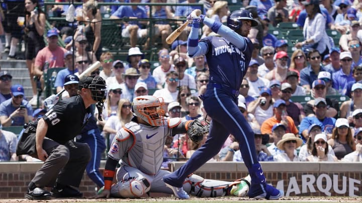 Jun 21, 2024; Chicago, Illinois, USA; Chicago Cubs outfielder Cody Bellinger (24) hits a single against the New York Mets during the first inning at Wrigley Field.