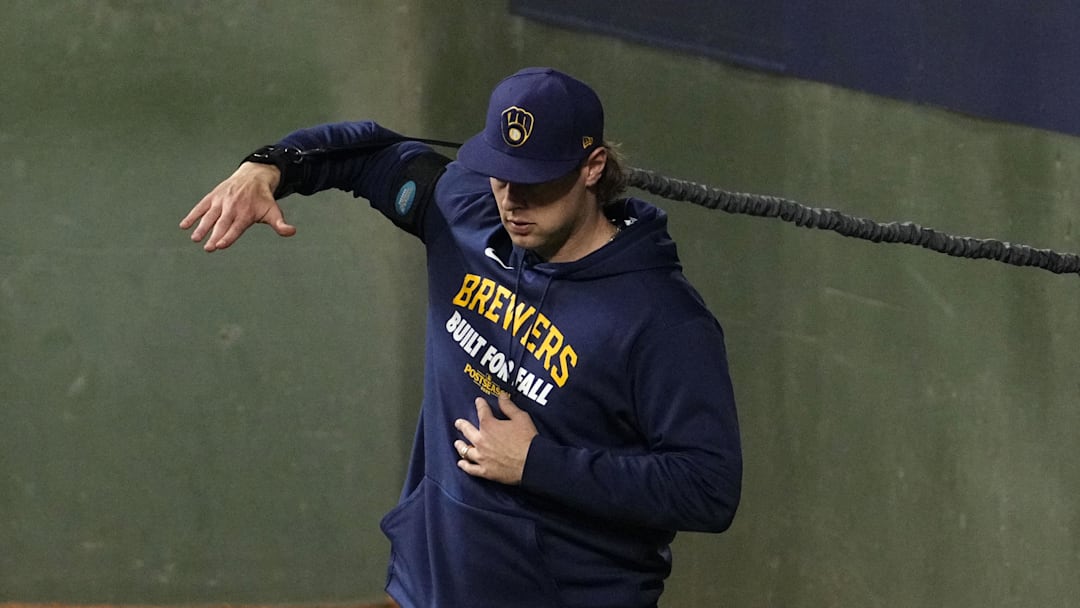 Oct 14, 2025; Milwaukee, Wisconsin, USA; Milwaukee Brewers pitcher Trevor Megill (29) stretches in the bullpen against the Los Angeles Dodgers in the ninth inning during game two of the NLCS round for the 2025 MLB playoffs at American Family Field. Mandatory Credit: Michael McLoone-Imagn Images