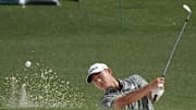Collin Morikawa hits from the bunker on the 18th at Augusta National.