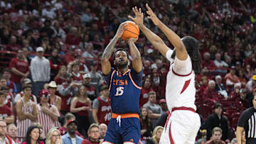 Dec 7, 2024; Fayetteville, Arkansas, USA;  Texas-San Antonio Roadrunners forward Jonnivius Smith (15) shoots over Arkansas Razorbacks forward Jonas Aidoo (9) during the first half at Bud Walton Arena. Mandatory Credit: Brett Rojo-Imagn Images