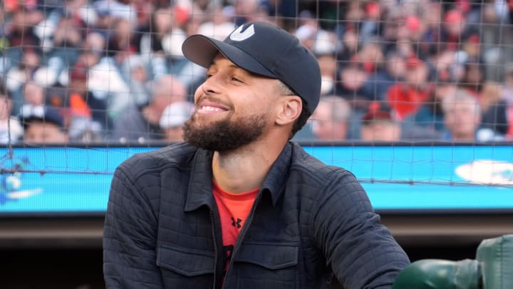 May 31, 2024; San Francisco, California, USA; Golden State Warriors guard Stephen Curry leans against the dugout railing before the game against the New York Yankees at Oracle Park. Mandatory Credit: Darren Yamashita-USA TODAY Sports