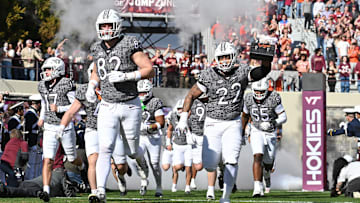 Nov 22, 2025; Blacksburg, Va.; Virginia Tech defensive lineman Kelvin Gilliam Jr. (22) carries the lunch pail into the stadium.