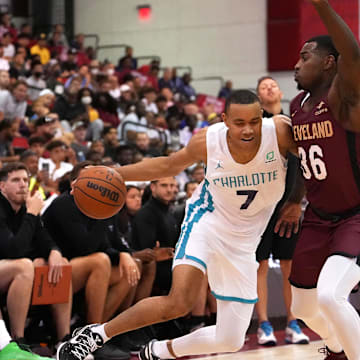 Jul 13, 2022; Las Vegas, NV, USA; Charlotte Hornets forward Bryce McGowens (7) dribbles against Cleveland Cavaliers guard Amauri Hardy (36) during an NBA Summer League game at Cox Pavilion. Mandatory Credit: Stephen R. Sylvanie-Imagn Images