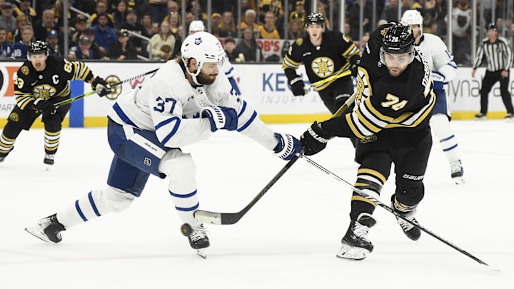 May 4, 2024; Boston, Massachusetts, USA; Boston Bruins left wing Jake DeBrusk (74) shoots the puck while Toronto Maple Leafs defenseman Timothy Liljegren (37) defends during the third period in game seven of the first round of the 2024 Stanley Cup Playoffs at TD Garden. Mandatory Credit: Bob DeChiara-Imagn Images