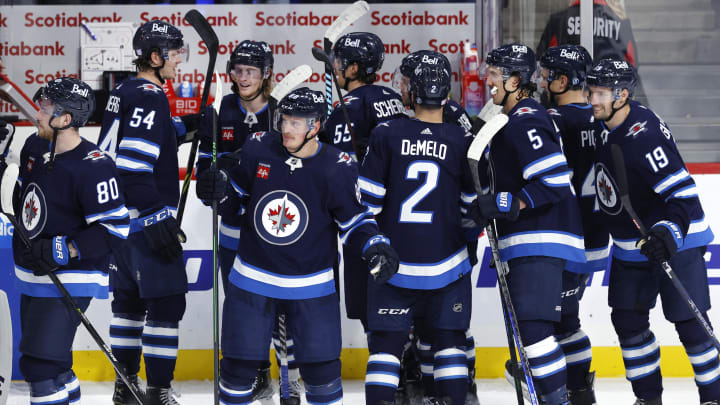 Nov 3, 2022; Winnipeg, Manitoba, CAN; Winnipeg Jets players celebrate their overtime win against the