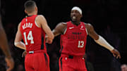 Dec 7, 2024; Miami, Florida, USA;  Miami Heat center Bam Adebayo (13) celebrates with guard Tyler Herro (14) after Herro made a three-point basket against the Phoenix Suns during the second half at Kaseya Center. Mandatory Credit: Jim Rassol-Imagn Images