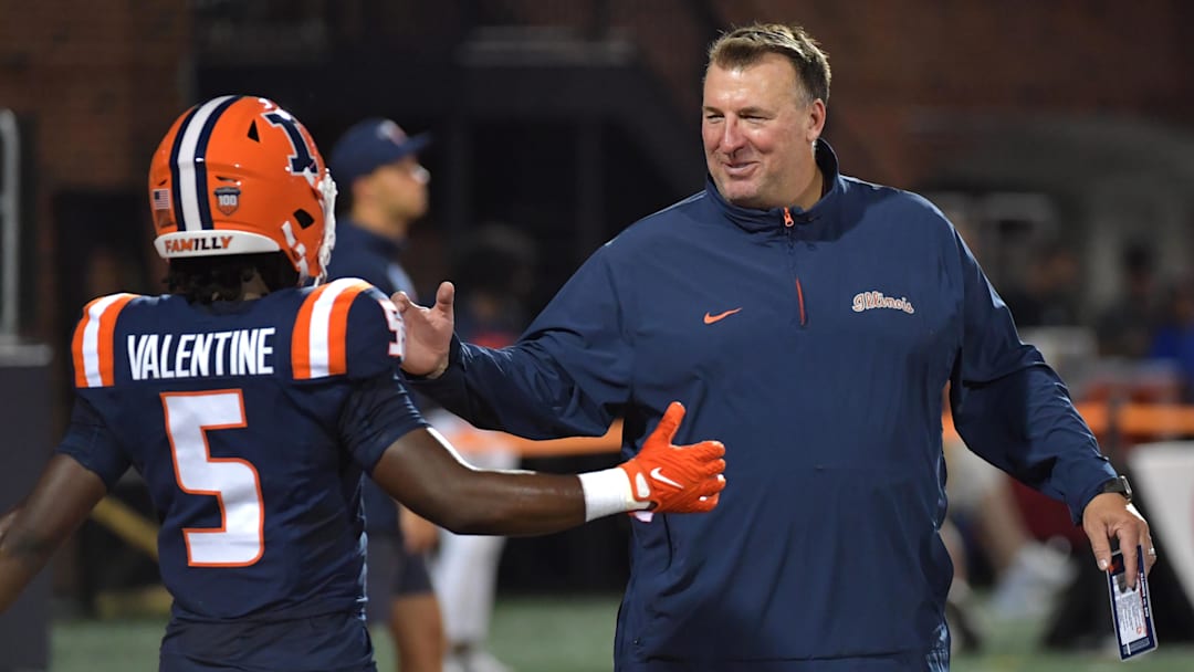 Aug 29, 2024; Champaign, Illinois, USA;  Illinois Fighting Illini head coach Bret Bielema greets running back Ca'Lil Valentine (5) before the first half at Memorial Stadium.