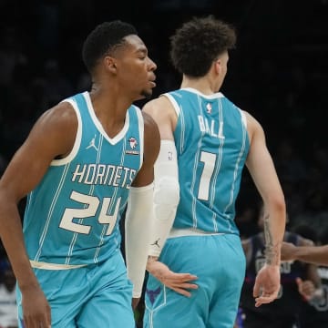 Oct 27, 2023; Charlotte, North Carolina, USA; Charlotte Hornets guard LaMelo Ball (1) gives forward Brandon Miller (24) a low high five after a play against the Detroit Pistons during the second quarter at Spectrum Center. Mandatory Credit: Jim Dedmon-USA TODAY Sports