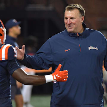 Aug 29, 2024; Champaign, Illinois, USA;  Illinois Fighting Illini head coach Bret Bielema greets running back Ca'Lil Valentine (5) before the first half at Memorial Stadium. Mandatory Credit: Ron Johnson-Imagn Images