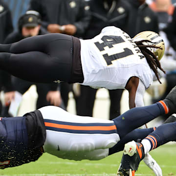 Oct 19, 2025; Chicago, Illinois, USA; New Orleans Saints running back Alvin Kamara (41) dives for a first down against the Chicago Bears during the second half at Soldier Field. Mandatory Credit: Mike Dinovo-Imagn Images