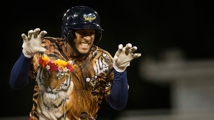 Fort Myers Mighty Mussels' Emmanuel Rodriguez (13) reacts after hitting a home run during the bottom of the seventh inning of the Single-A MiLB game between the Jupiter Hammerheads and Fort Myers Mighty Mussels, Friday, April 15, 2022, at Hammond Stadium in Fort Myers, Fla. The Fort Myers Mighty Mussels defeated the Jupiter Hammerheads 12-0.Carole Baskin threw out the first pitch, and the Mussels wore special Tiger-themed jerseys on Big Cat Rescue Night.

Fort Myers Mighty Mussels Big Cat Rescue