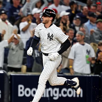 Oct 8, 2025; Bronx, New York, USA; New York Yankees third baseman Ryan McMahon (19) hits a solo home run during the third inning against the Toronto Blue Jays during game four of the ALDS round for the 2025 MLB playoffs at Yankee Stadium. Mandatory Credit: Vincent Carchietta-Imagn Images