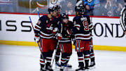 Oct 18, 2024; Winnipeg, Manitoba, CAN;  Winnipeg Jets forward Cole Perfetti (91) is congratulated by his teammates on his goal against the San Jose Sharks during the third period at Canada Life Centre. Mandatory Credit: Terrence Lee-Imagn Images