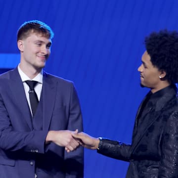 Jun 25, 2025; Brooklyn, NY, USA; Cooper Flagg and Dylan Harper shake hands on stage before the 2025 NBA Draft at Barclays Center. Mandatory Credit: Brad Penner-Imagn Images