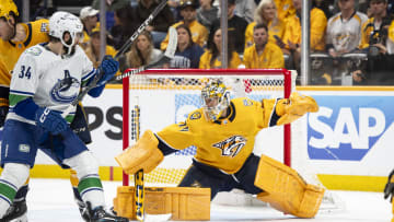 May 3, 2024; Nashville, Tennessee, USA; during the second period in game six of the first round of the 2024 Stanley Cup Playoffs at Bridgestone Arena. Mandatory Credit: Steve Roberts-USA TODAY SportsNashville Predators goaltender Juuse Saros (74) blocks the puck against the Vancouver Canucks 
